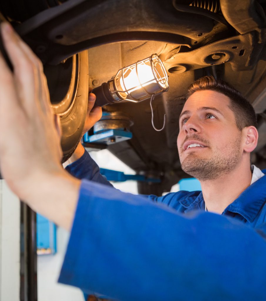 Mechanic inspecting underneath a vehicle - MOT Sutton Coldfield